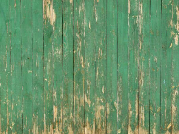 Weathered planks set in vertical fashion with scratches and fading paint.